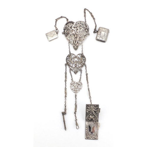 602 - Victorian silver chatelaine with vesta, stamp case, propelling pencil and aide-mémoire, the chatelai... 