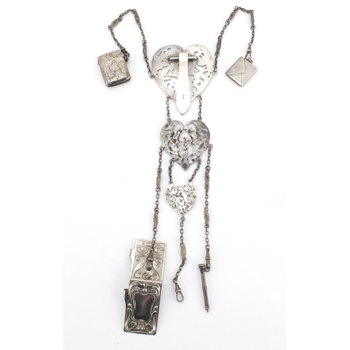 602 - Victorian silver chatelaine with vesta, stamp case, propelling pencil and aide-mémoire, the chatelai... 