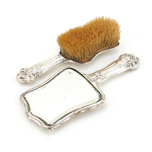 615 - Art Nouveau silver backed hand mirror and brush embossed with stylised flowers and maiden heads, Bir... 