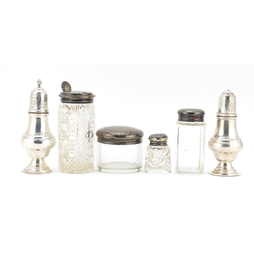 594 - Silver items including two baluster shaped casters, three cut glass jars with silver lids and a cut ... 