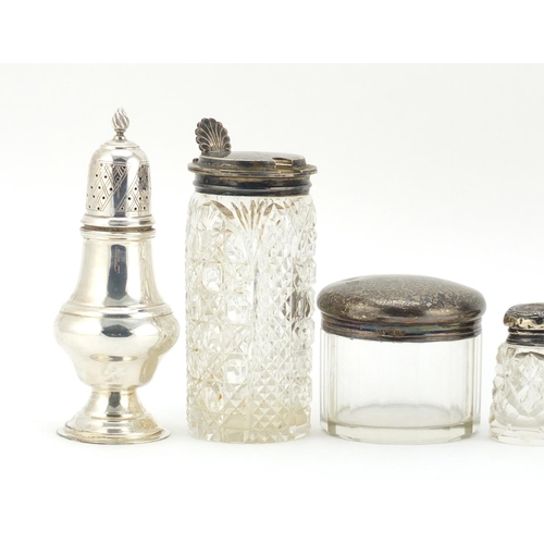 594 - Silver items including two baluster shaped casters, three cut glass jars with silver lids and a cut ... 