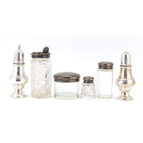 594 - Silver items including two baluster shaped casters, three cut glass jars with silver lids and a cut ... 