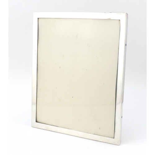 633 - Edwardian rectangular silver easel photo frame, indistinct maker's mark London 1919, 29.5cm x 24.5cm