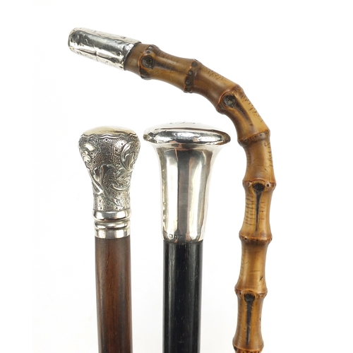 121 - Three silver mounted walking sticks including one with ebony shaft, the largest 93cm in length