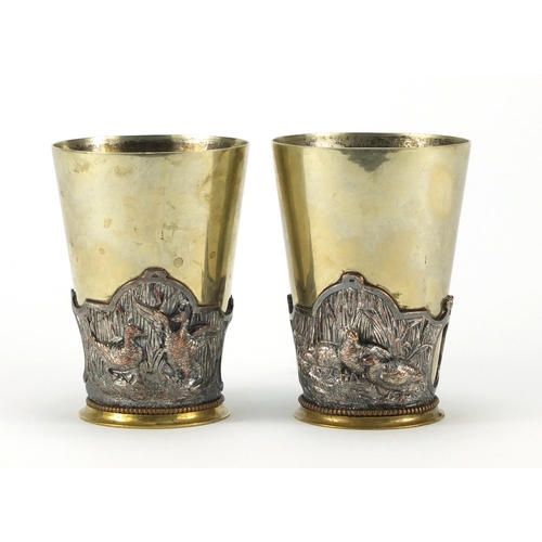 237 - Pair of silver plated and copper beakers, relief decorated with ducks and partridges, 12cm high