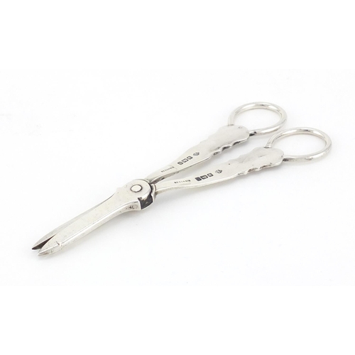 591 - Pair of silver grape scissors by William Hutton & Sons Ltd, Sheffield 1908, 15.5cm in length, 71.4g