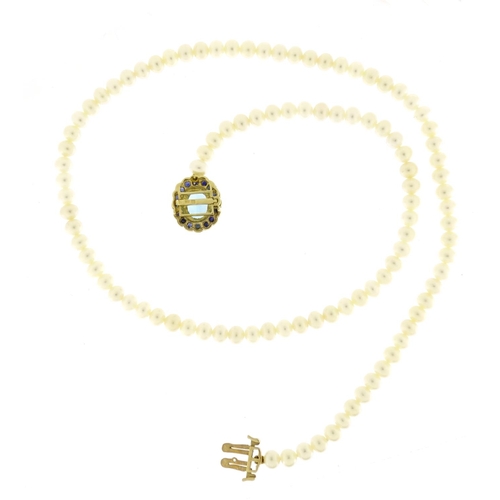 697 - Single string pearl necklace with 9ct gold blue stone and sapphire clasp, 44cm in length, 21.0g