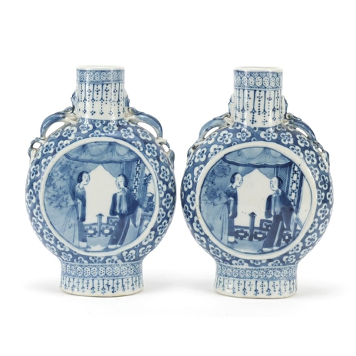 313 - Pair of Chinese blue and white porcelain moon flasks with twin handles, each hand painted with panel... 