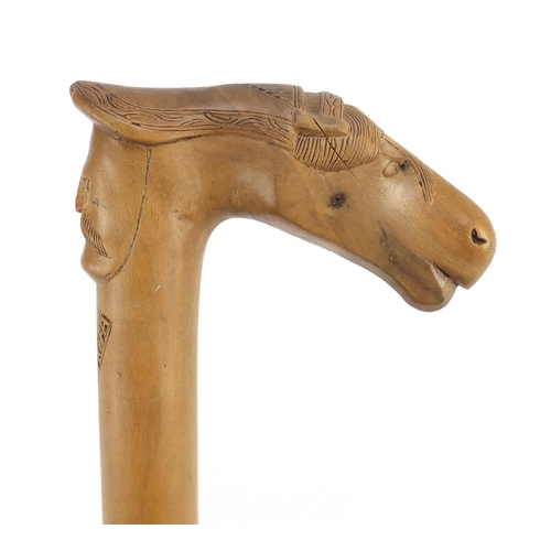 117 - Continental walking stick with carved Cypriot head and horse head handle, 89cm in length