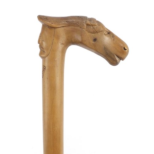 117 - Continental walking stick with carved Cypriot head and horse head handle, 89cm in length