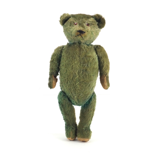 130 - Old green straw filled teddy bear with jointed limbs, 53cm in length