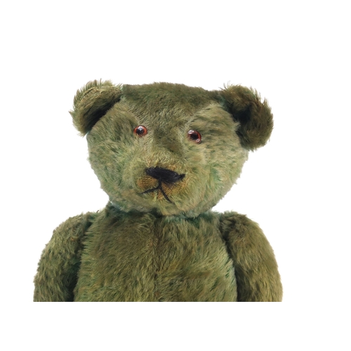 130 - Old green straw filled teddy bear with jointed limbs, 53cm in length