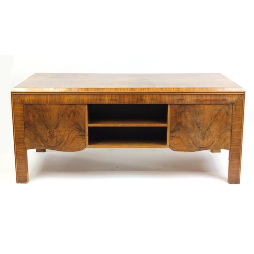 2012 - Art Deco figured walnut desk fitted with a pair of serpentine fronted cupboard doors, 79cm H x 181cm... 