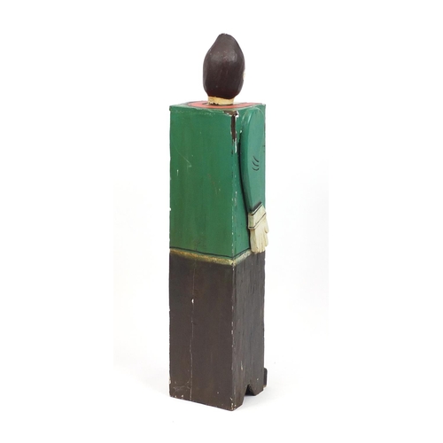 2047 - Novelty carved wood two door cupboard in the form of a man in a green coat, 106cm high