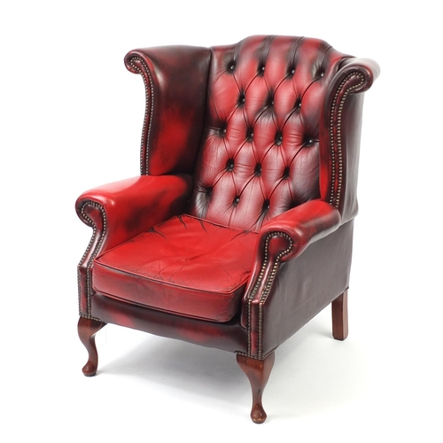 2003 - Ox blood leather wing and back armchair, 98cm high