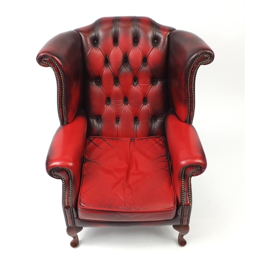 2003 - Ox blood leather wing and back armchair, 98cm high