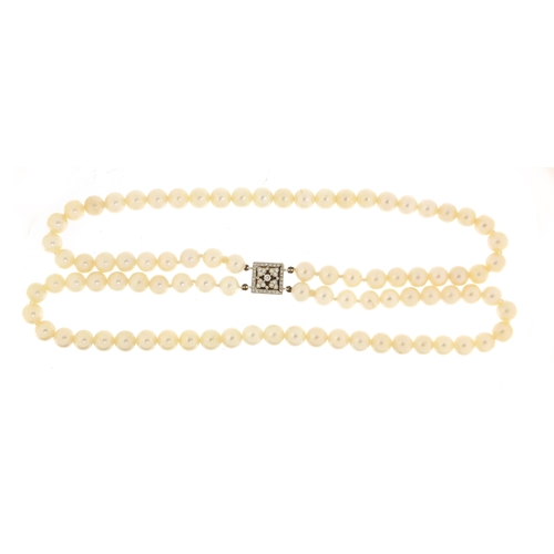 655 - Two string pearl necklace with 18ct white gold diamond clasp, 32cm in length, 62.0g