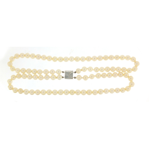 655 - Two string pearl necklace with 18ct white gold diamond clasp, 32cm in length, 62.0g