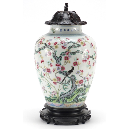 305a - Chinese porcelain vase with carved hardwood lid and stand, finely hand painted in the famille rose p... 