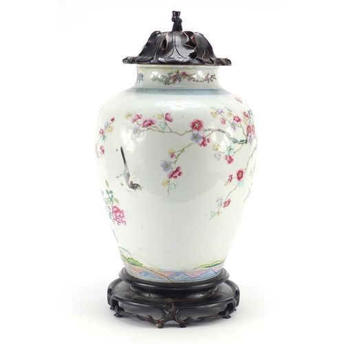 305a - Chinese porcelain vase with carved hardwood lid and stand, finely hand painted in the famille rose p... 