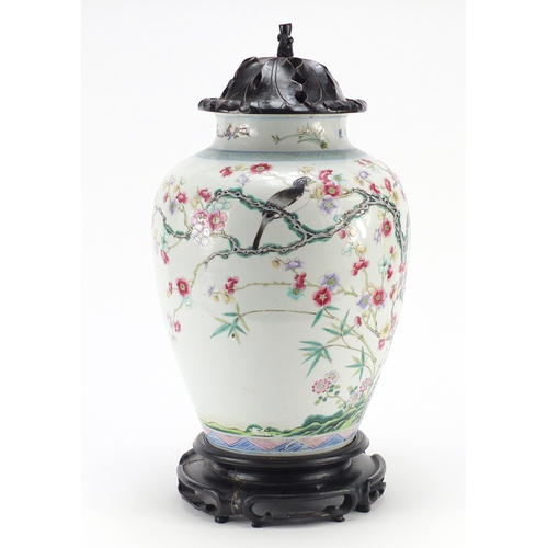 305a - Chinese porcelain vase with carved hardwood lid and stand, finely hand painted in the famille rose p... 