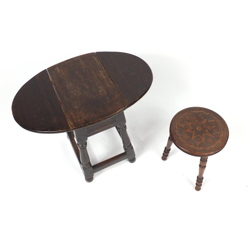 77 - Walnut three legged stool and a dropleaf table