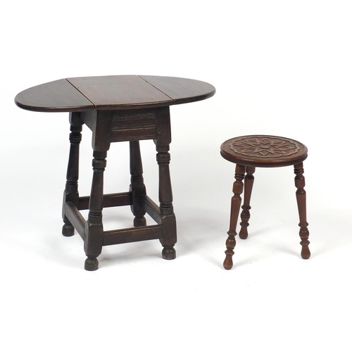 77 - Walnut three legged stool and a dropleaf table