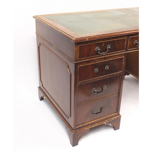 22 - Mahogany twin pedestal desk fitted with an arrangement of nine drawers, 78cm H x 138cm W x 69cm D