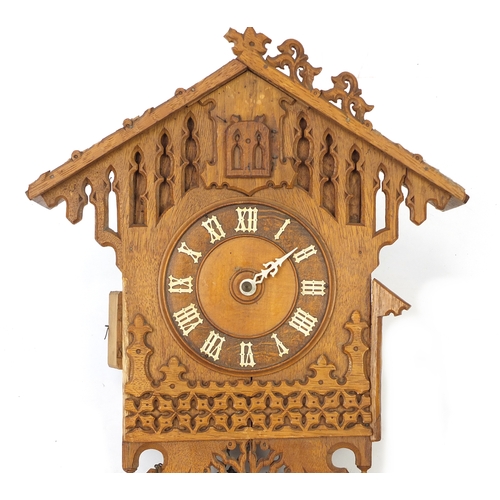25 - Carved light oak black forest cuckoo clock, 50cm high
