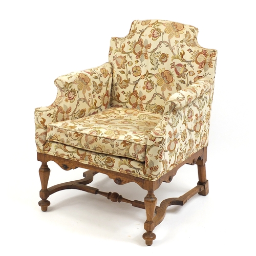 2023 - Arts and Crafts design carved oak chair arm chair with cream floral upholstery, 87cm high