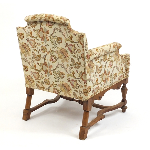 2022 - Arts and Crafts design carved oak chair arm chair with cream floral upholstery, 87cm high