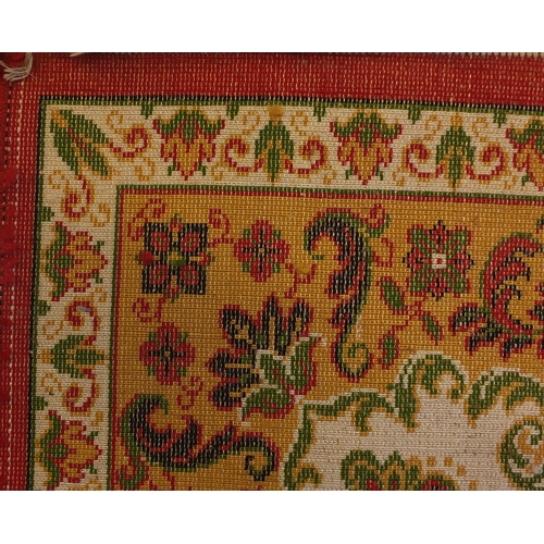 2044A - Samira Worsted pile carpet with all over floral pattern onto a red, cream and green ground, 374cm x ... 