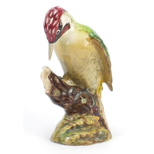 190 - Beswick woodpecker perched on a branch, numbered 1218, 22cm high