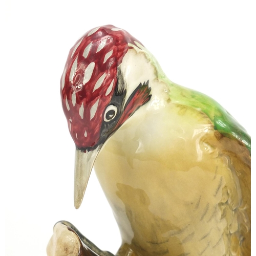 190 - Beswick woodpecker perched on a branch, numbered 1218, 22cm high