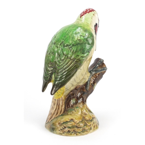 190 - Beswick woodpecker perched on a branch, numbered 1218, 22cm high