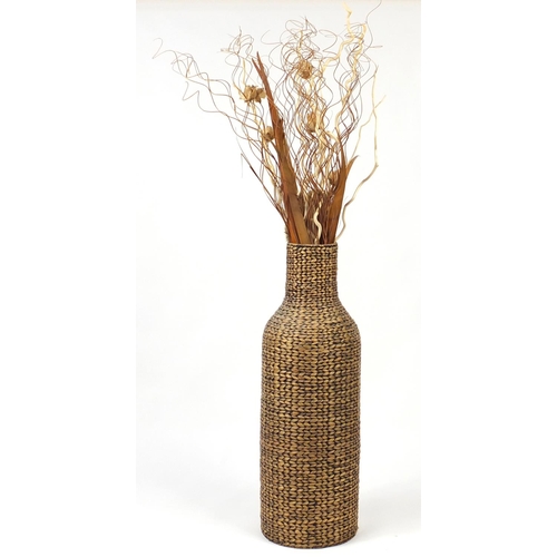 58 - Large floorstanding wicker vase with floral display, 175cm high