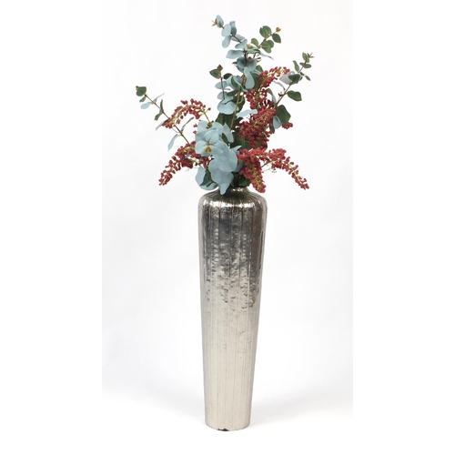 63 - Silvered floorstanding vase with artificial display, 67cm high