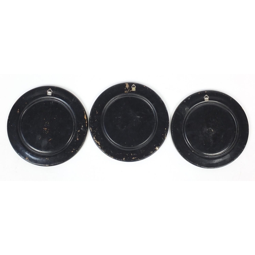 215 - Set of three Egyptian ebonised plates, 25cm diameter