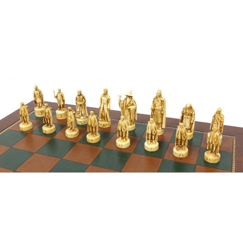 54 - Mahogany chess board with tooled leather insert and a Lord of the Rings chess set