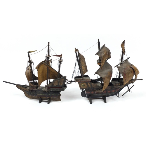 211 - Two model ships on stands, the larger 60cm wide