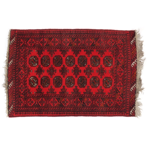 26 - Persian red ground rug with all over geometric design, 120cm x 80cm