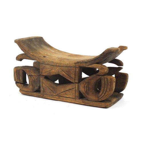 71 - Tribal interest carved wood head rest, 51cm in length