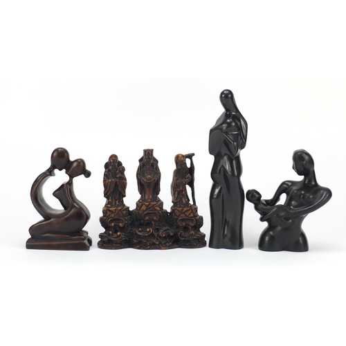 160 - Decorative figures including two carved stone examples, the larger 24cm high