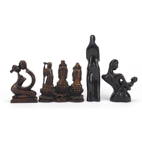 160 - Decorative figures including two carved stone examples, the larger 24cm high