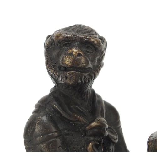 187 - Patinated bronze candlestick in the form of a monkey, 16cm high