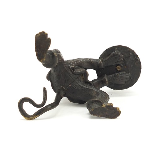 187 - Patinated bronze candlestick in the form of a monkey, 16cm high