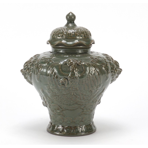 100 - Chinese pottery green glazed jar and cover, relief decorated with a phoenix and lion mask handles, 2... 