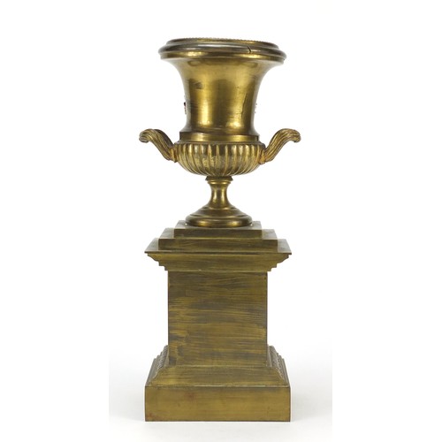 120 - Ornate gilt brass campana urn on stand, 30cm high