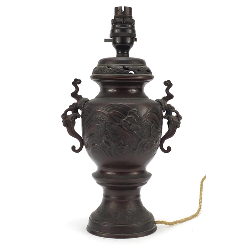 2165 - Japanese patinated bronze lamp with twin handles decorated with fish, 33cm high
