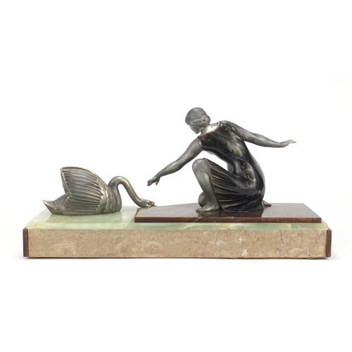 2185 - Art Deco sculpture of a young female and swan raised on a marble and onyx base, 42.5cm wide